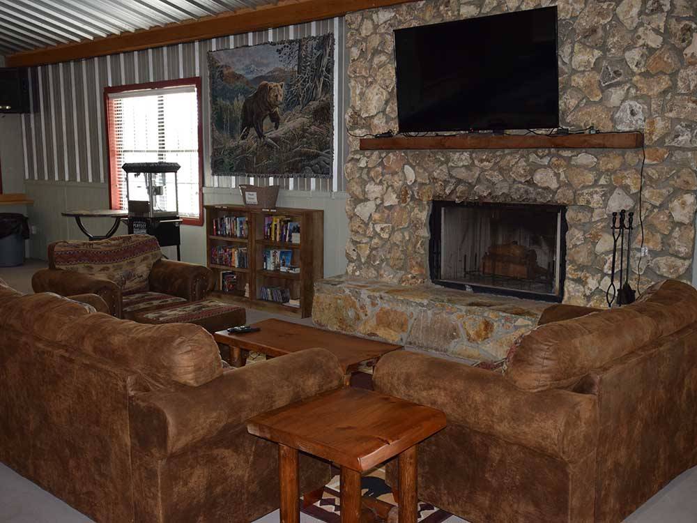 Couches around a fireplace at WILD FRONTIER RV RESORT