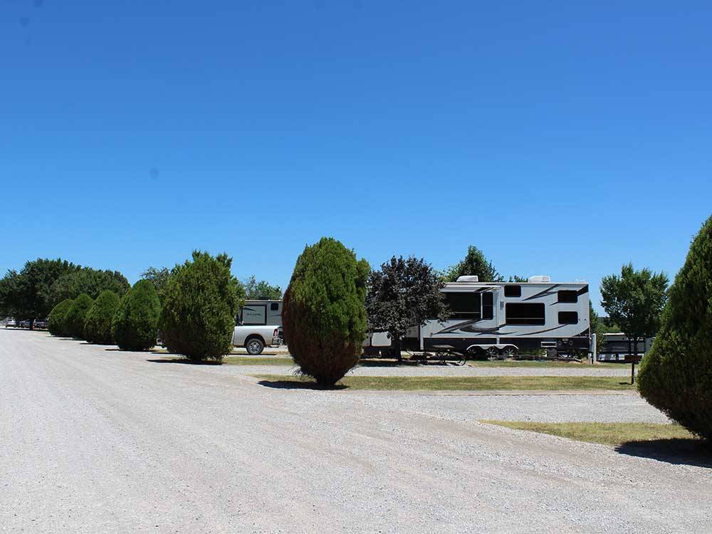 A row of gravel RV sites at ARBUCKLE RV RESORT