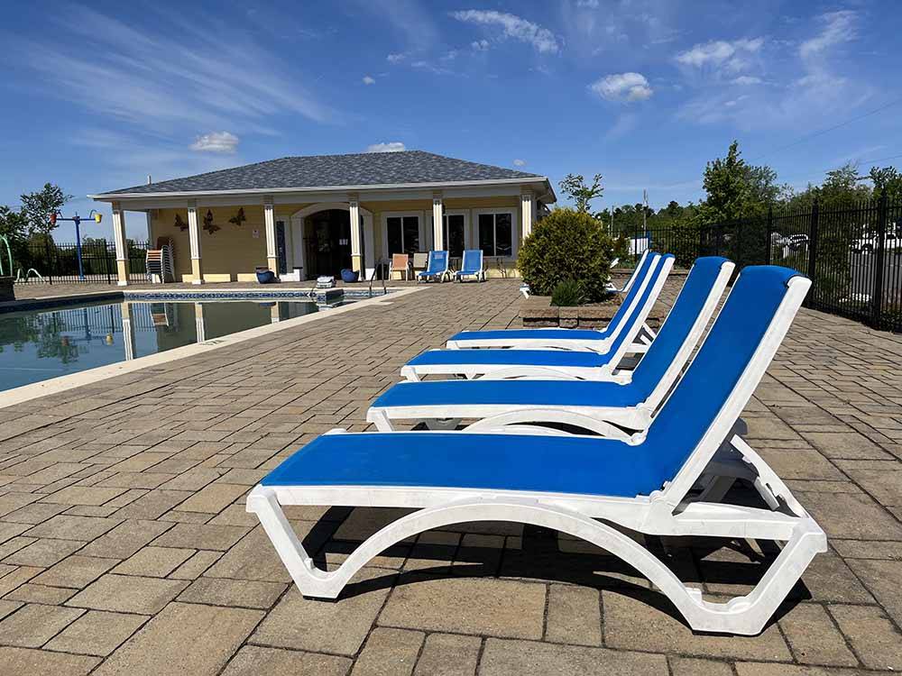 Lounge chairs around the pool at CAMPING LA CLE DES CHAMPS RV RESORT