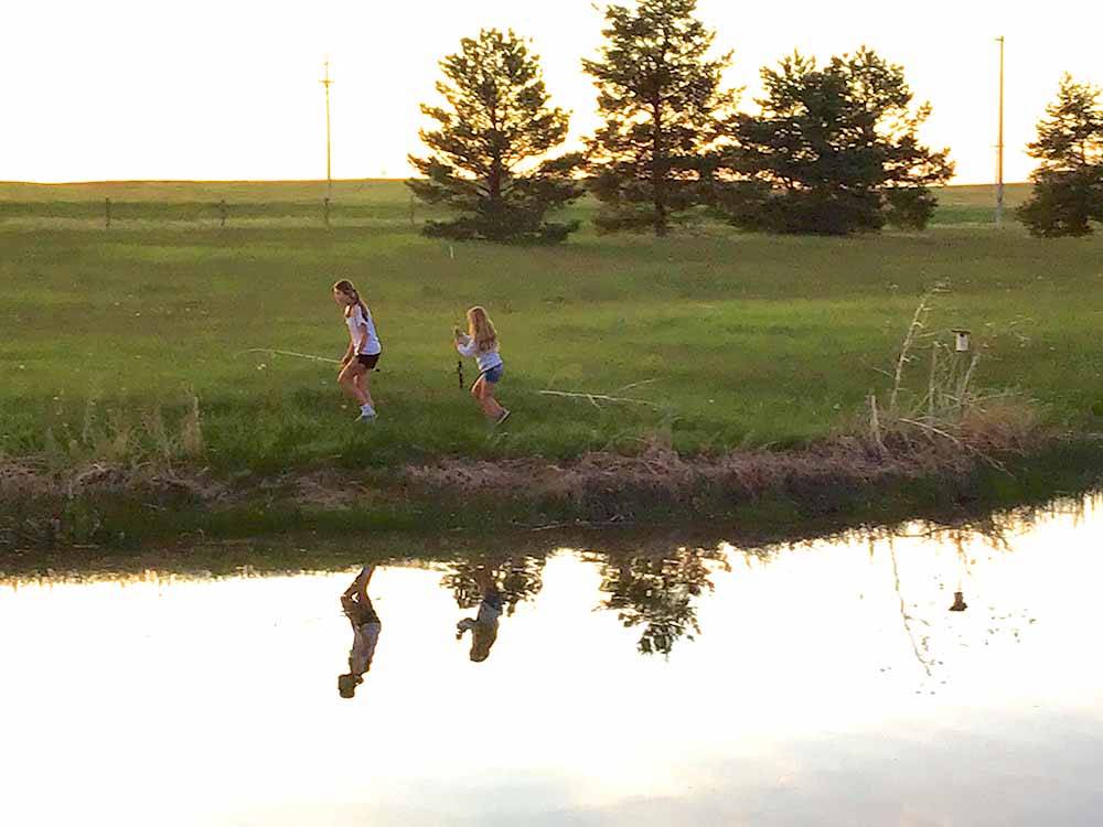 Two girls playing near the lake at FISHBERRY CAMPGROUND