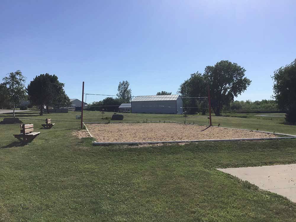 Sand Volleyball pit with benches for spectators at BEYONDER GETAWAY AT LAZY ACRES