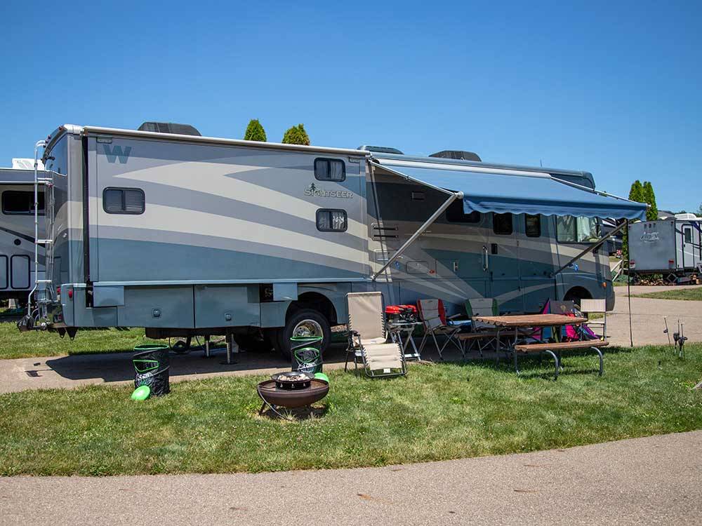 A motorhome with it's awning out at EVERGREEN PARK RV RESORT