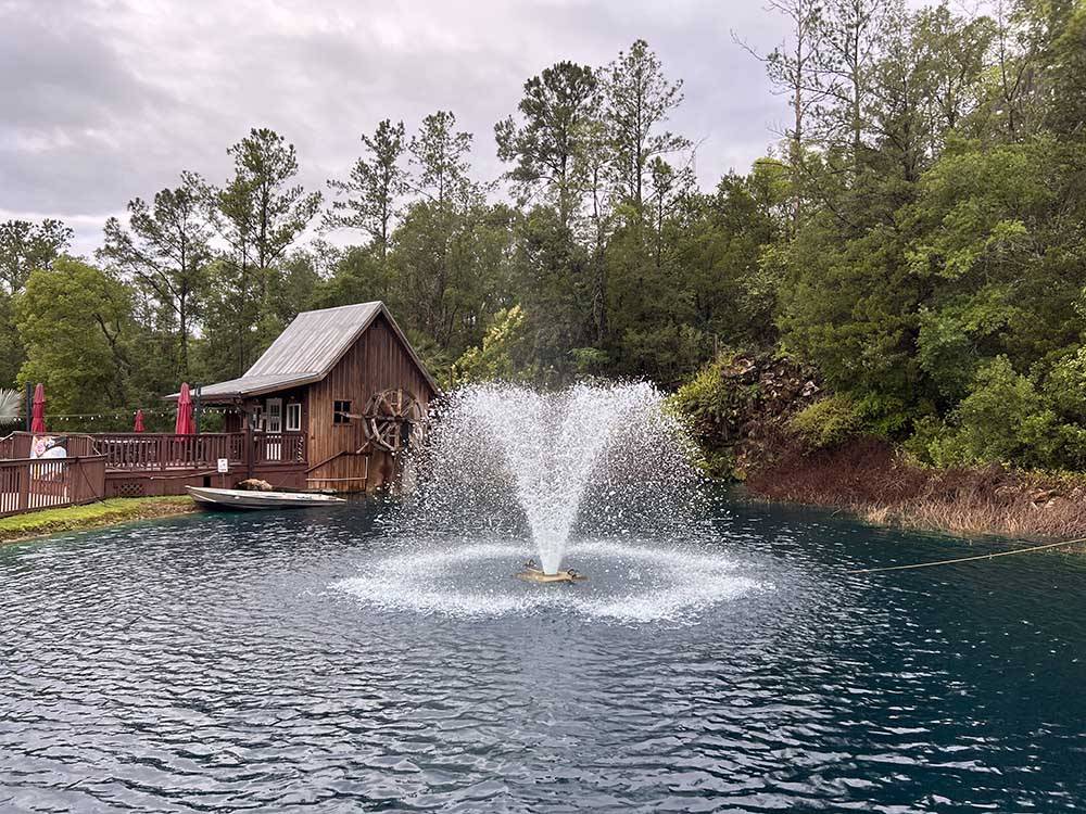 A fountain in the middle of the lake at WILLISTON CROSSINGS RV RESORT