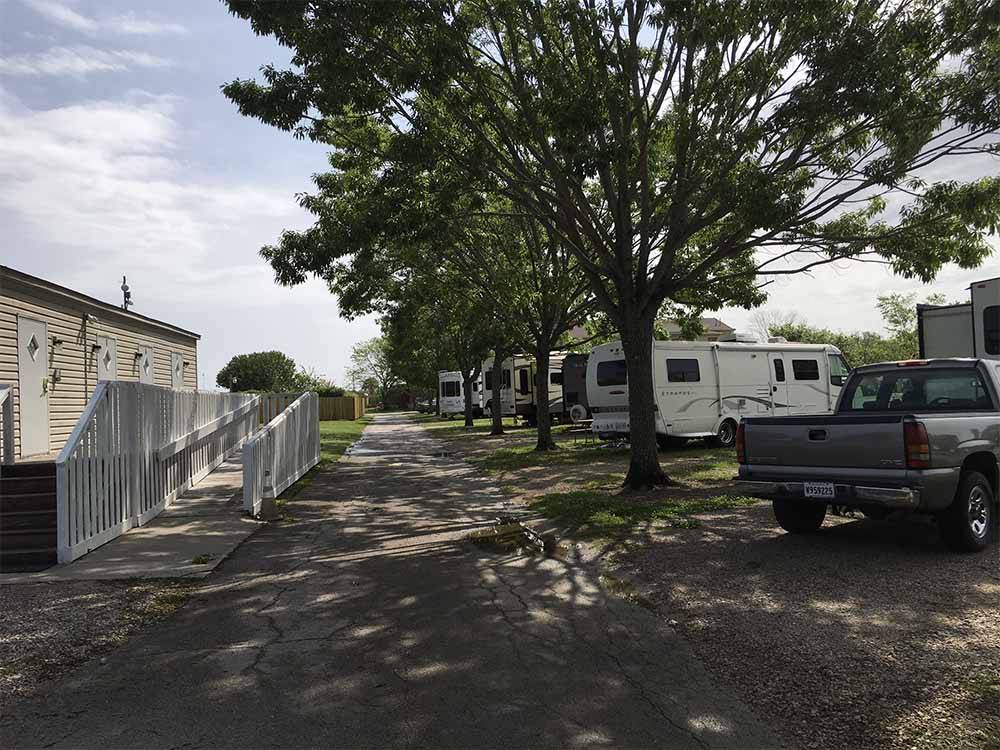 A row of RV sites and a ramp leading up to the office at FROG CITY RV PARK