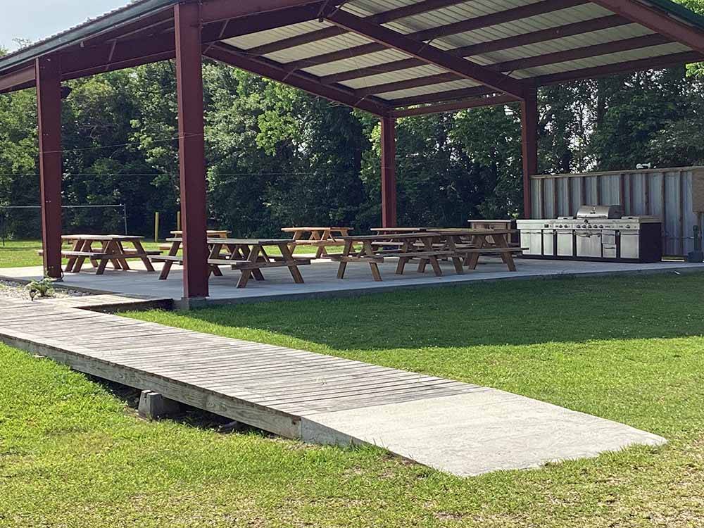 The picnic tables under the pavilion at FROG CITY RV PARK