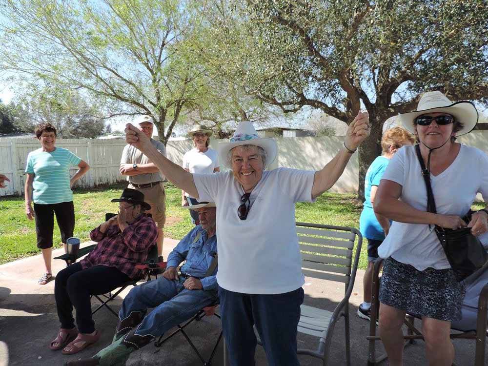 A group of people cheering at LAZY PALMS RANCH RV PARK