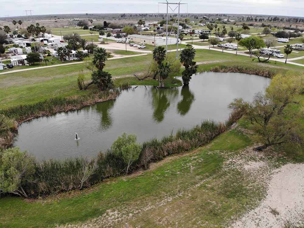 An aerial view of the lake at LAZY PALMS RANCH RV PARK