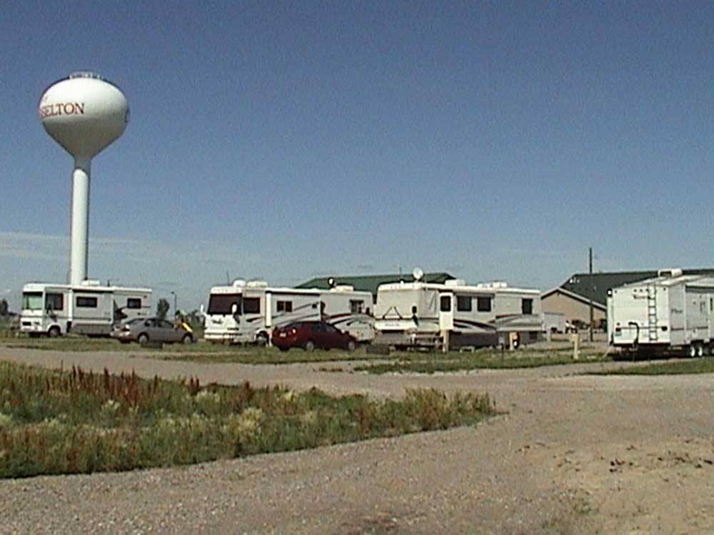 RVs with tall white water tower in the background at GOVERNORS' RV PARK CAMPGROUND