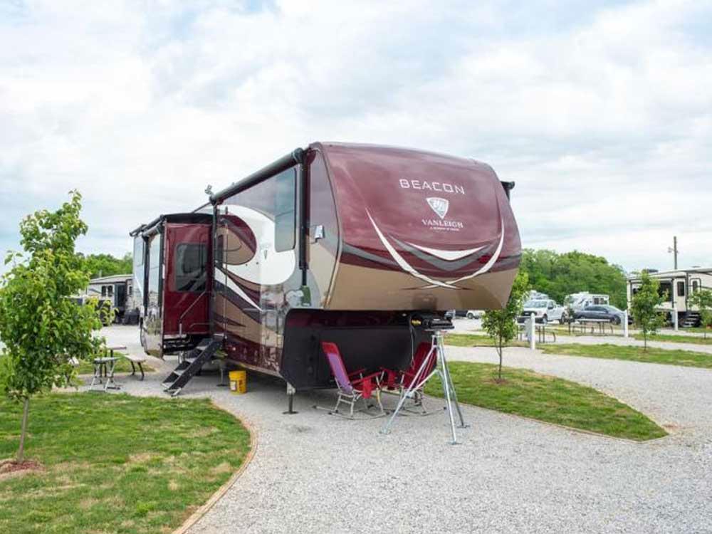 A fifth wheel trailer parked in a gravel site at HERITAGE ACRES RV PARK