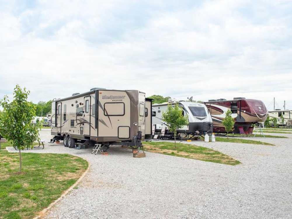 A row of trailers in paved sites at HERITAGE ACRES RV PARK