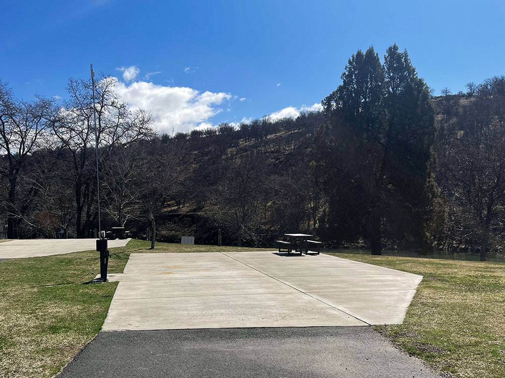 A paved RV site with patio and picnic table at Klamath Ranch Resort / Blue Heron RV Park