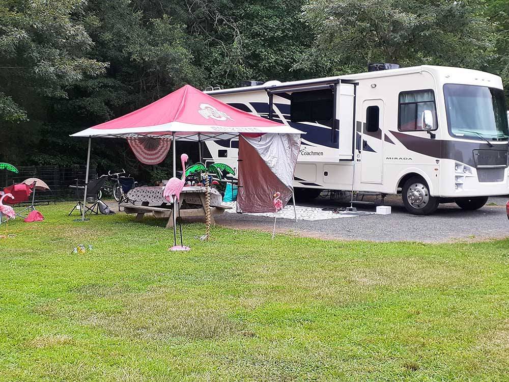 A covered picnic bench next to a motorhome at DAN RIVER CAMPGROUND