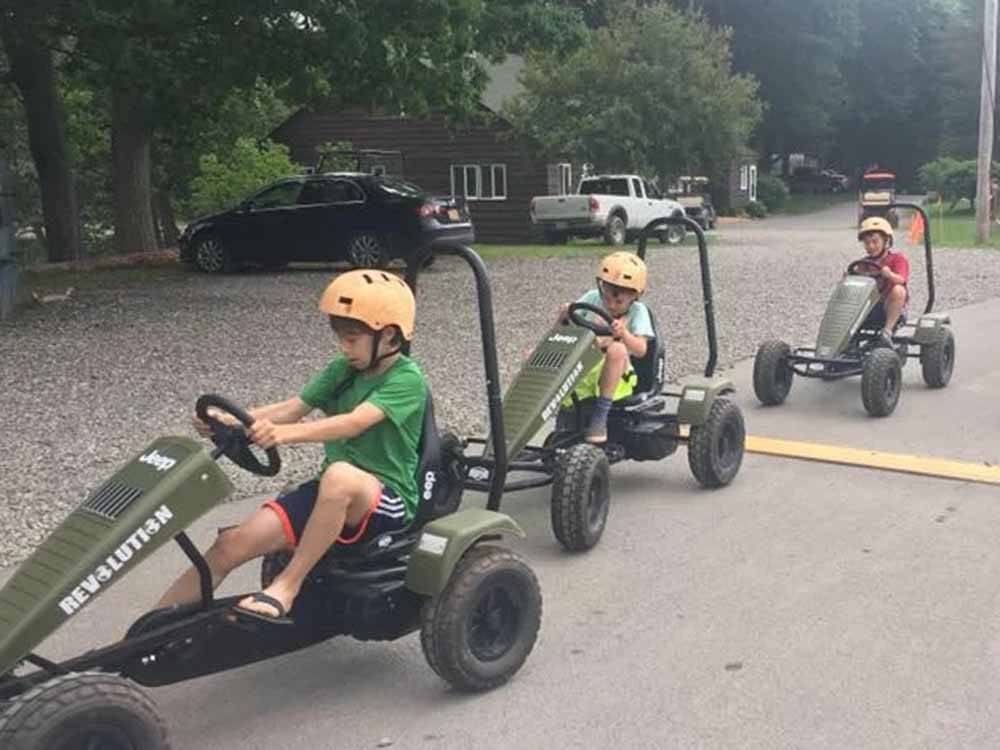 Kids driving pedal cars at WAUBEEKA FAMILY CAMPGROUND