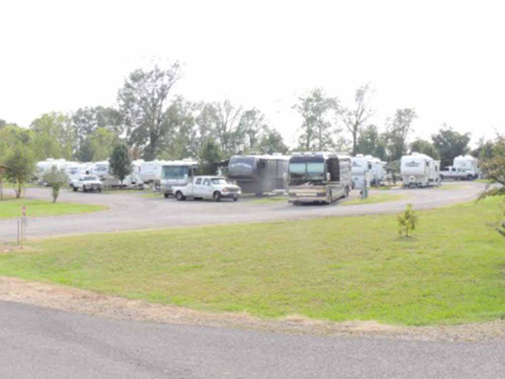 RV campsite with motorhomes and trucks at IVYS COVE RV RETREAT