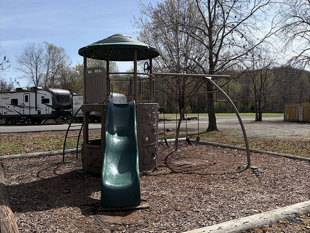 The playground with a slide and swings