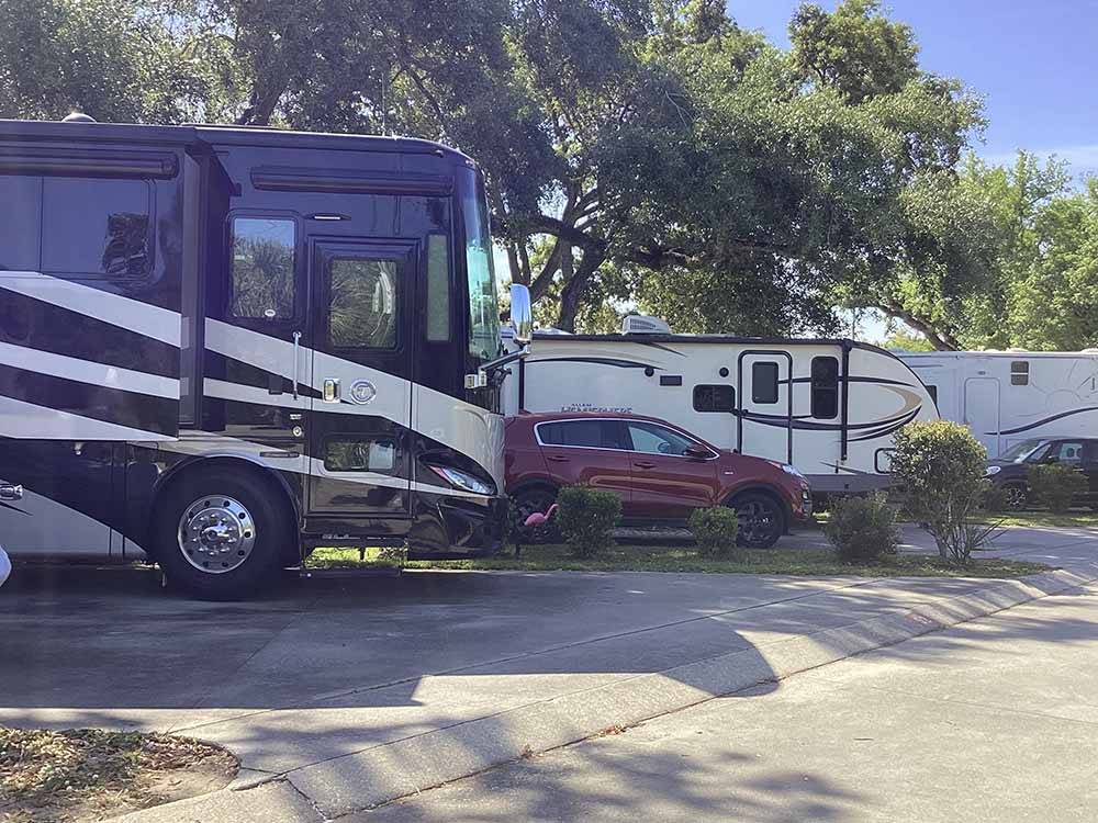 A motorhome in an RV site at MAJESTIC OAKS RV RESORT