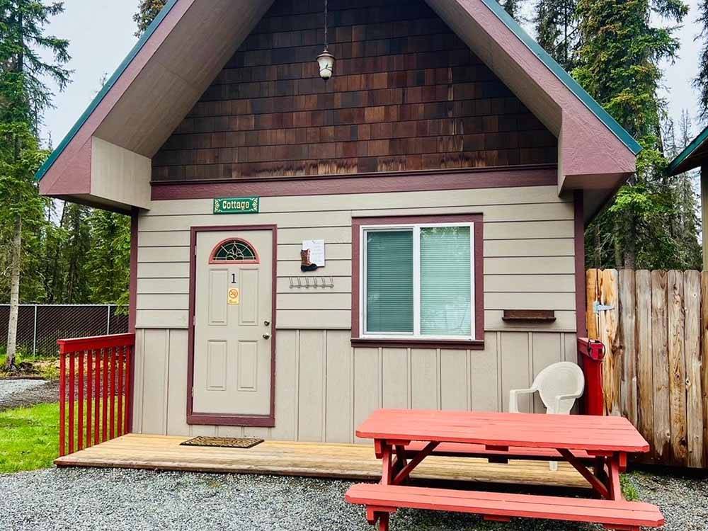 One of the cottage rentals with a bench at KLONDIKE RV PARK & COTTAGES