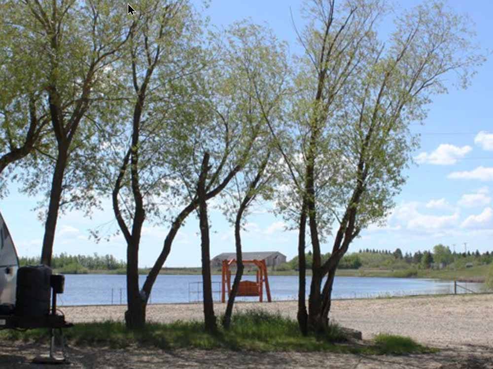 A bench in front of the lake at HERITAGE LAKE CAMPGROUND