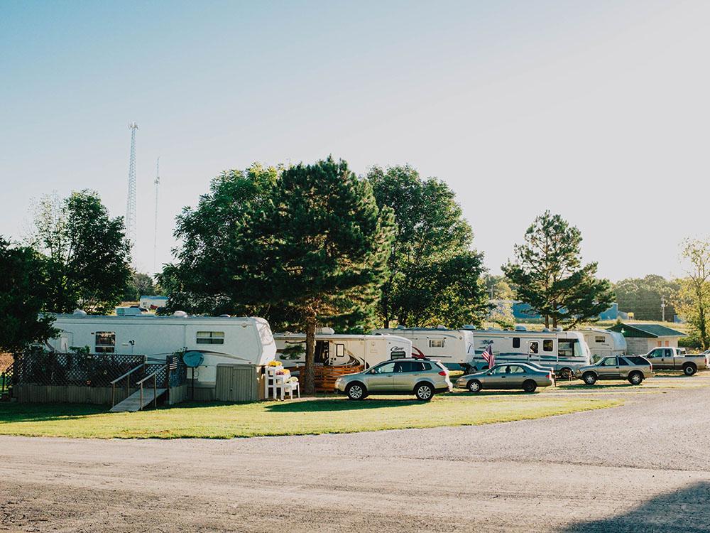 A row of RVs parked in sites at SILVER SPRINGS RV PARK