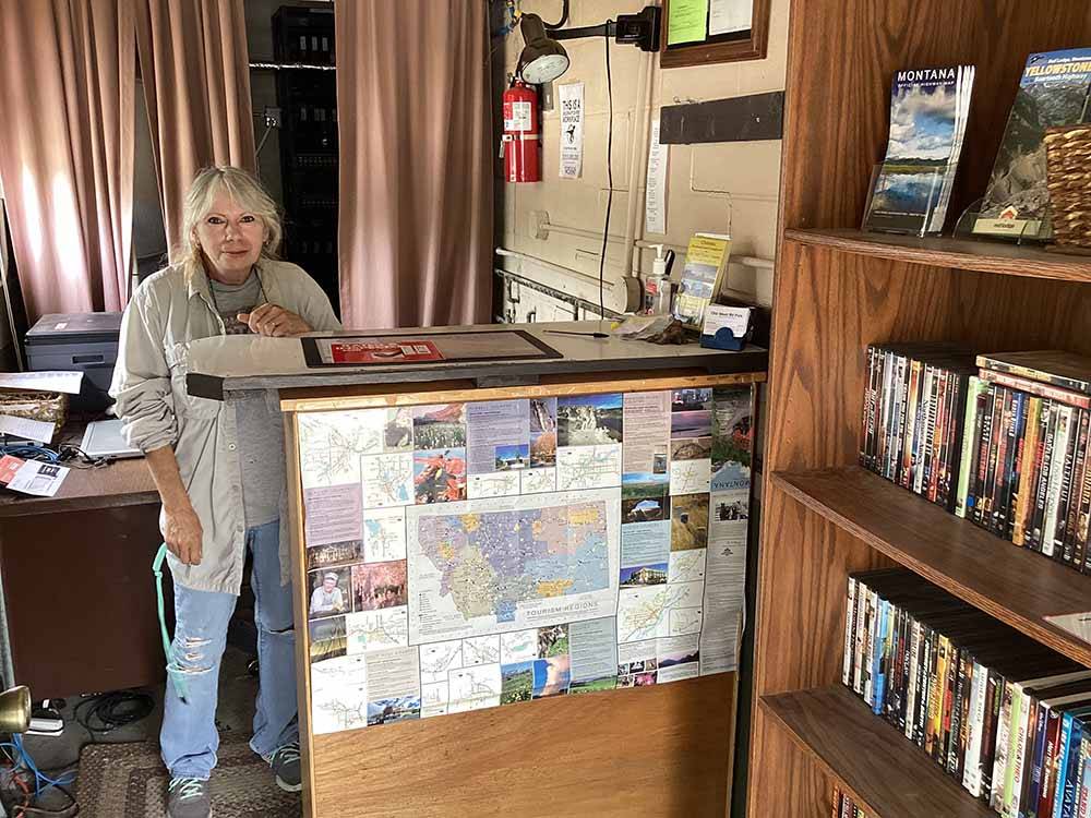 A woman standing behind the front desk at OLD WEST RV PARK