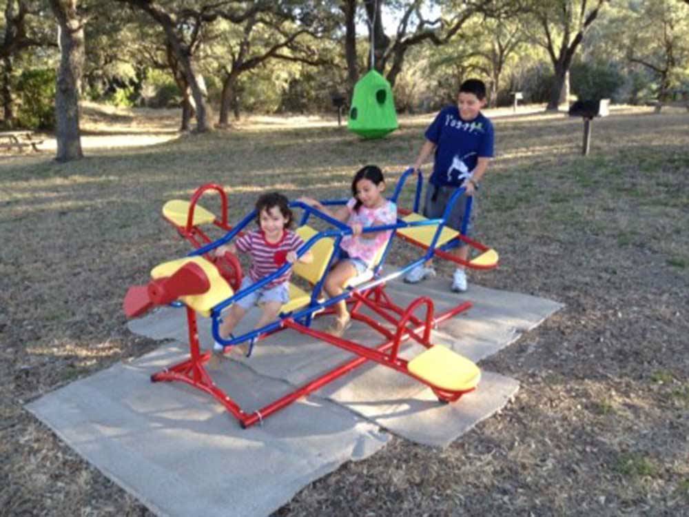 Kids playing on the playground equipment at BECS STORE & RV PARK