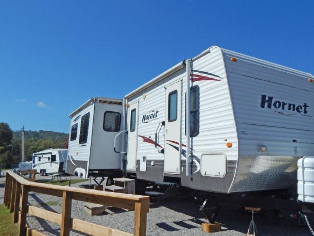 Travel trailer parked at a site at MOUNTAIN GLEN RV PARK & CAMPGROUND