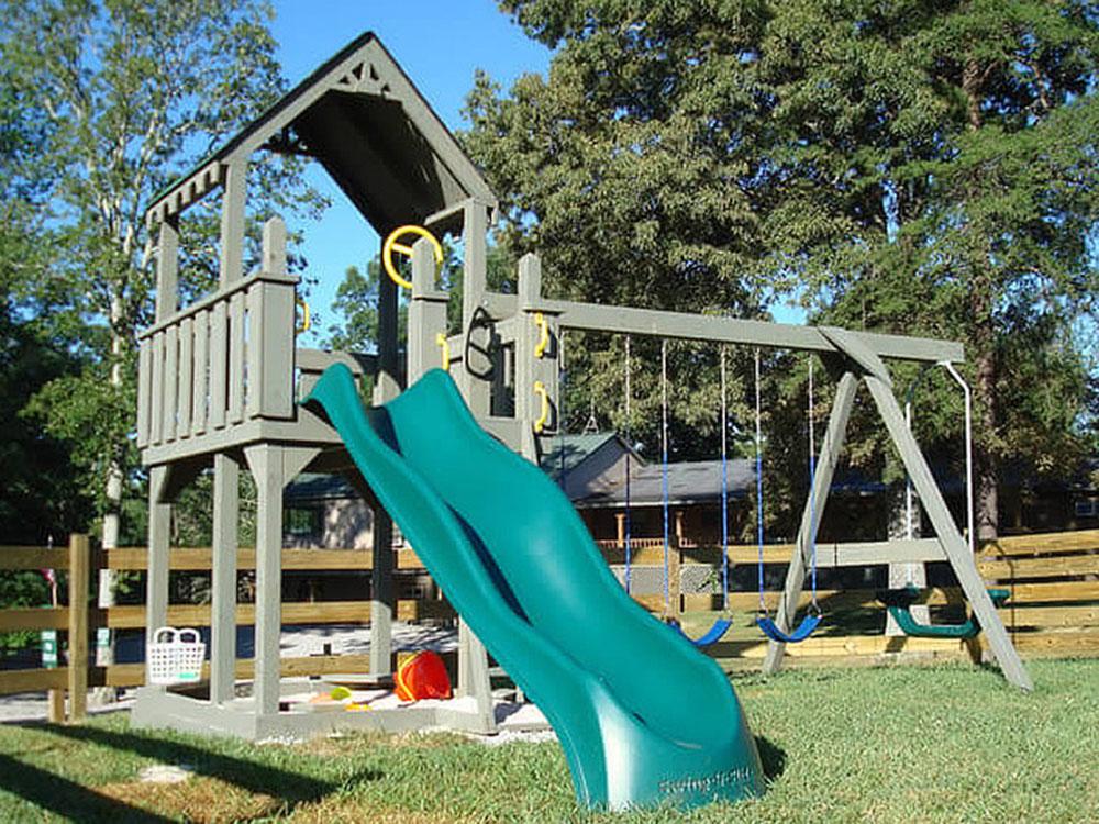 Playground with slide and swings at MOUNTAIN GLEN RV PARK & CAMPGROUND