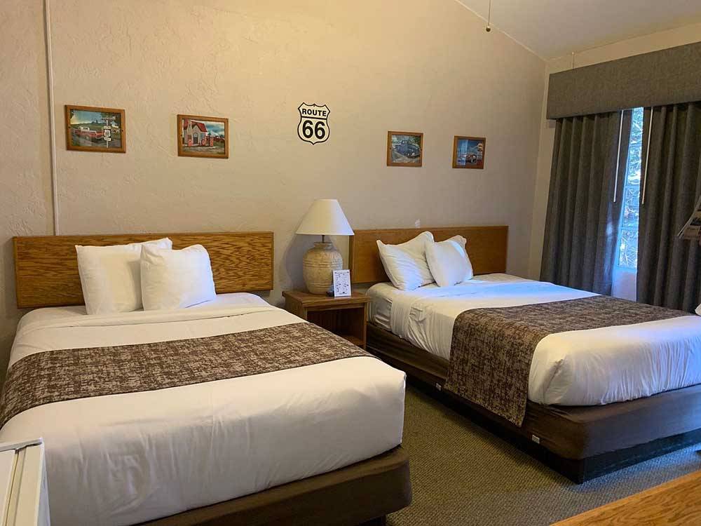 The beds inside of the motel room at CANYON MOTEL & RV PARK