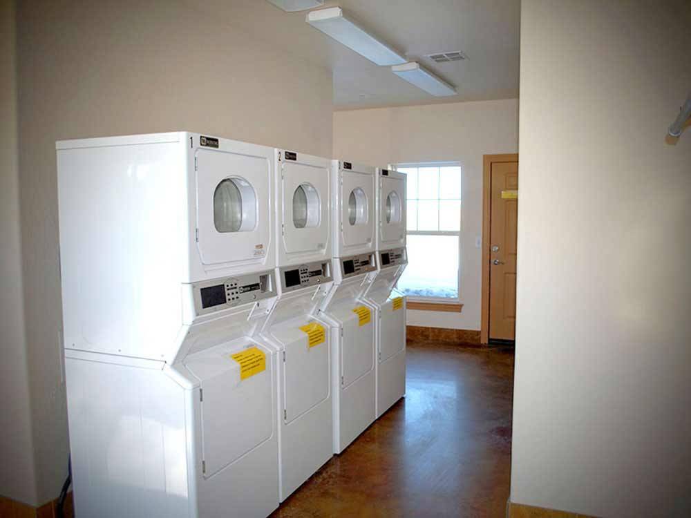 Laundry room with washer and dryers at OASIS RV RESORT
