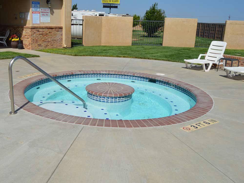 Outdoor hot tub in public pool area at OASIS RV RESORT