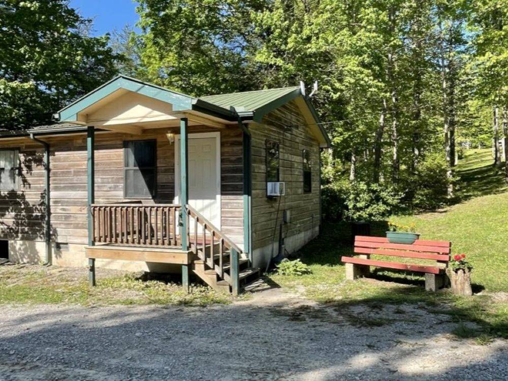 A rental cabin with bench outside