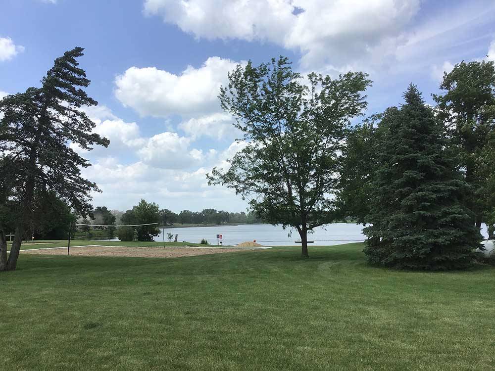 A grassy area by the water at LAKESHORE RV RESORT & CAMPGROUND