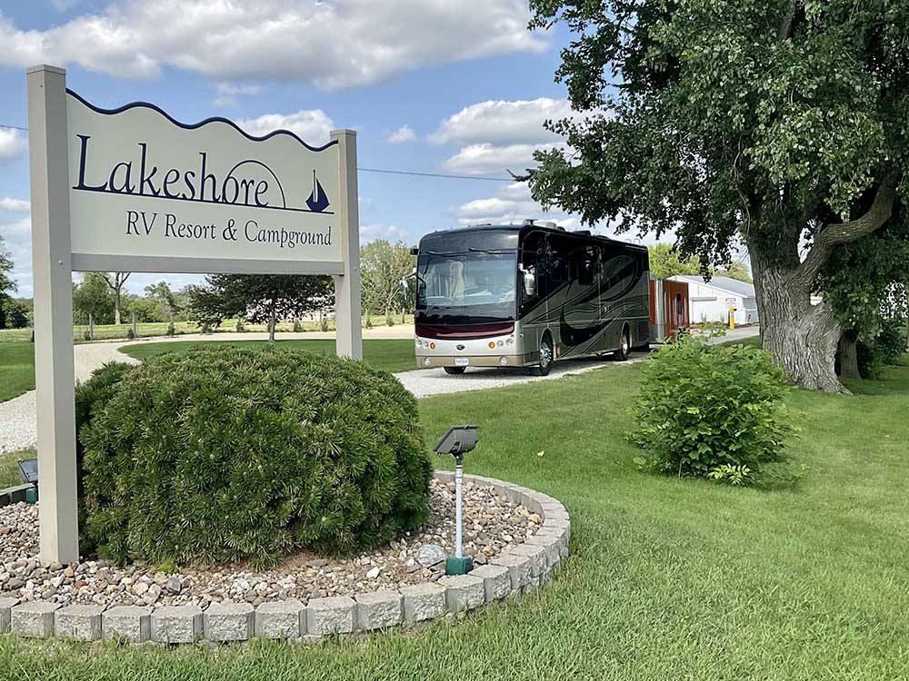 The front entrance sign with a motorhome coming in at LAKESHORE RV RESORT & CAMPGROUND
