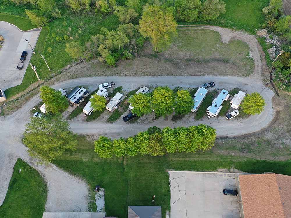 View of travel trailers in gravel sites at QUAIL RIDGE RV PARK