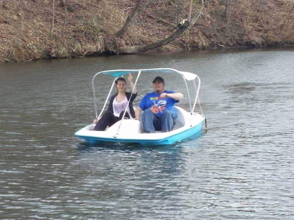 A couple on a paddleboat at AOK CAMPGROUND & RV PARK