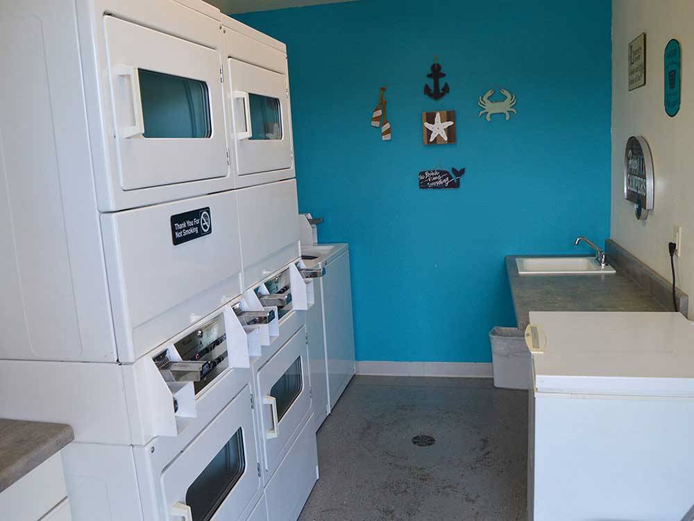 Laundry room with washer and dryers at CROSSROADS RV PARK