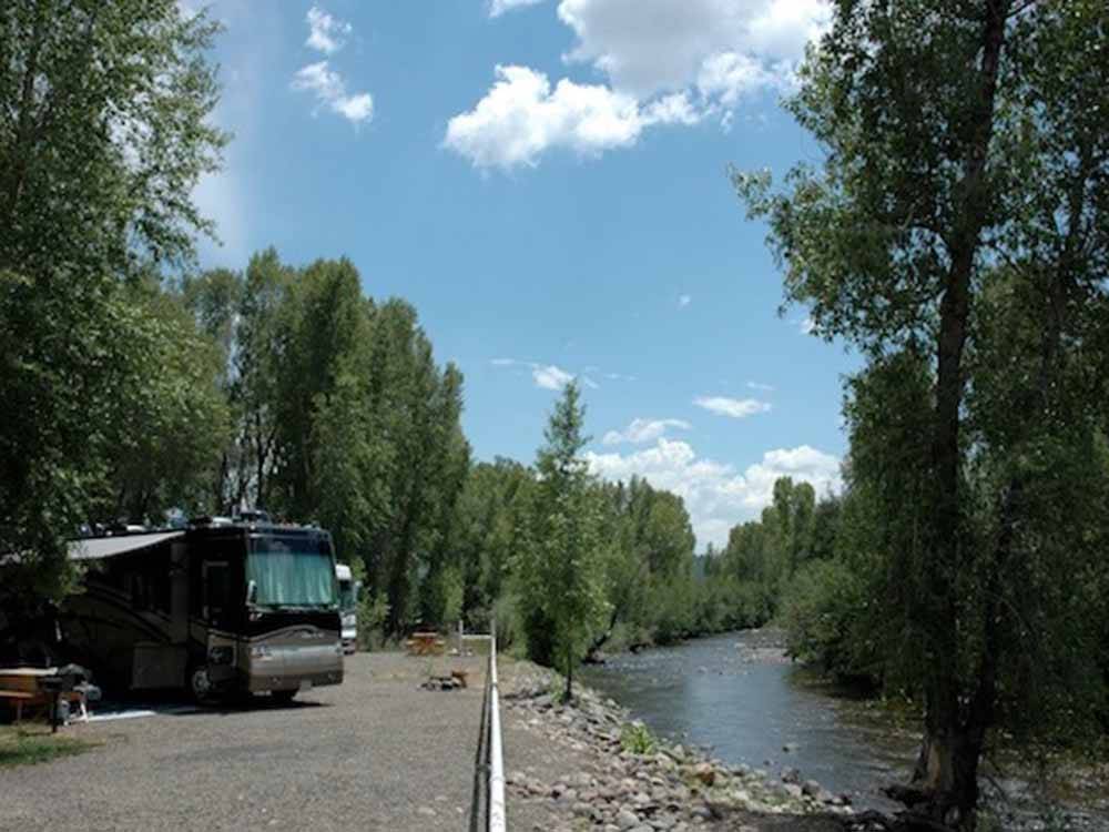 A motorhome overlooking the river at SKY MOUNTAIN RESORT RV PARK