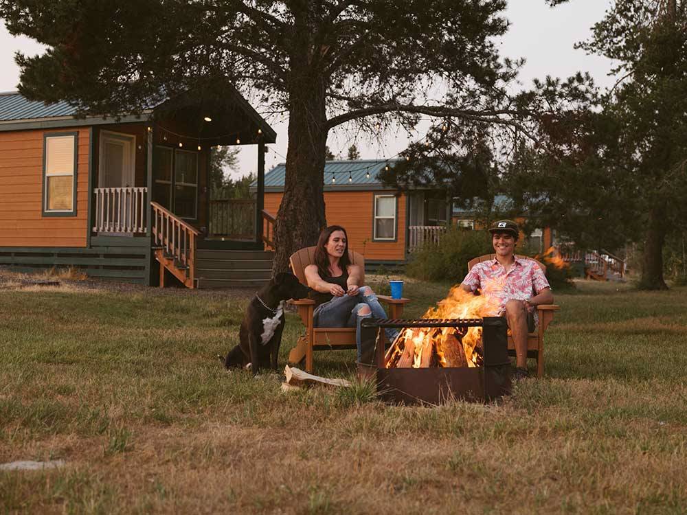 People sitting around a fire pit at SILVER COVE RV RESORT