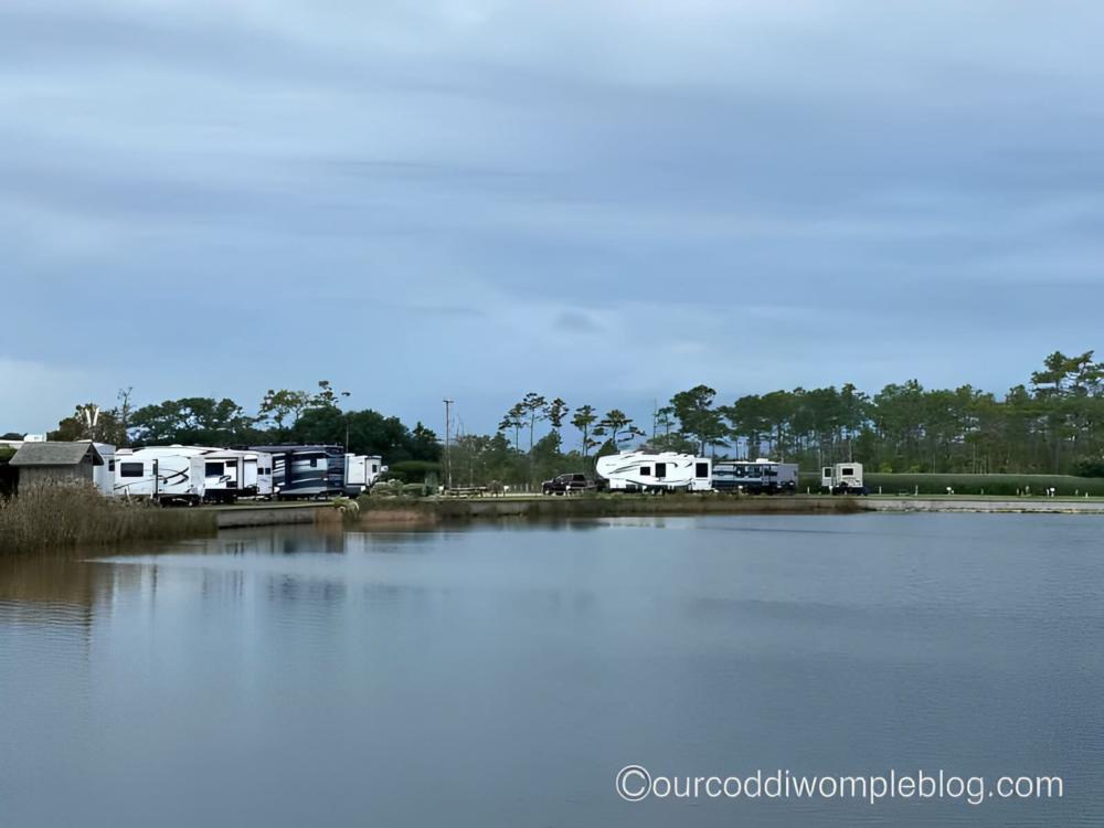 Lake with RV's parked near by at site The Refuge on Roanoke Island