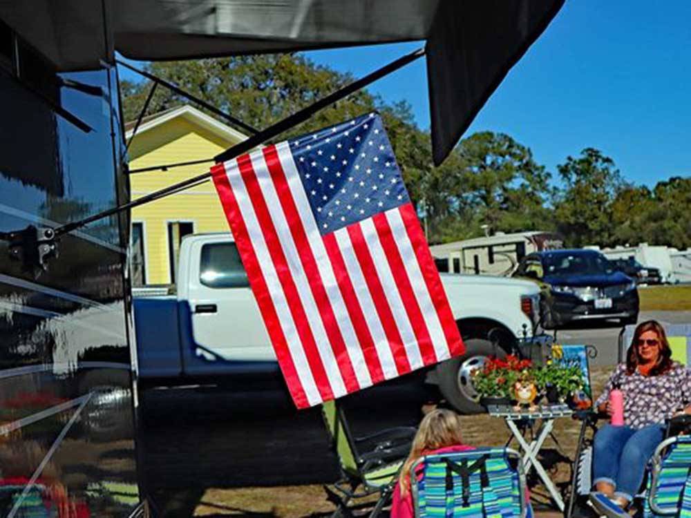 American flag posted outside RV at COYOTE VIEW RV PARK & RV REPAIR