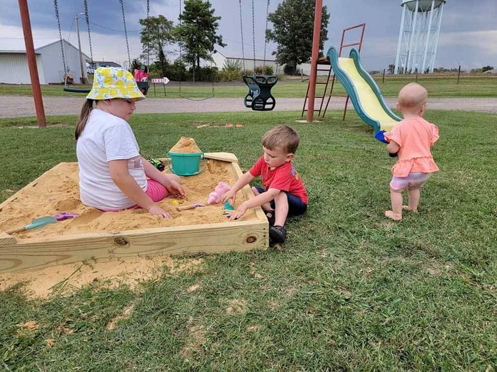 Children playing in sandbox at COYOTE VIEW RV PARK & RV REPAIR