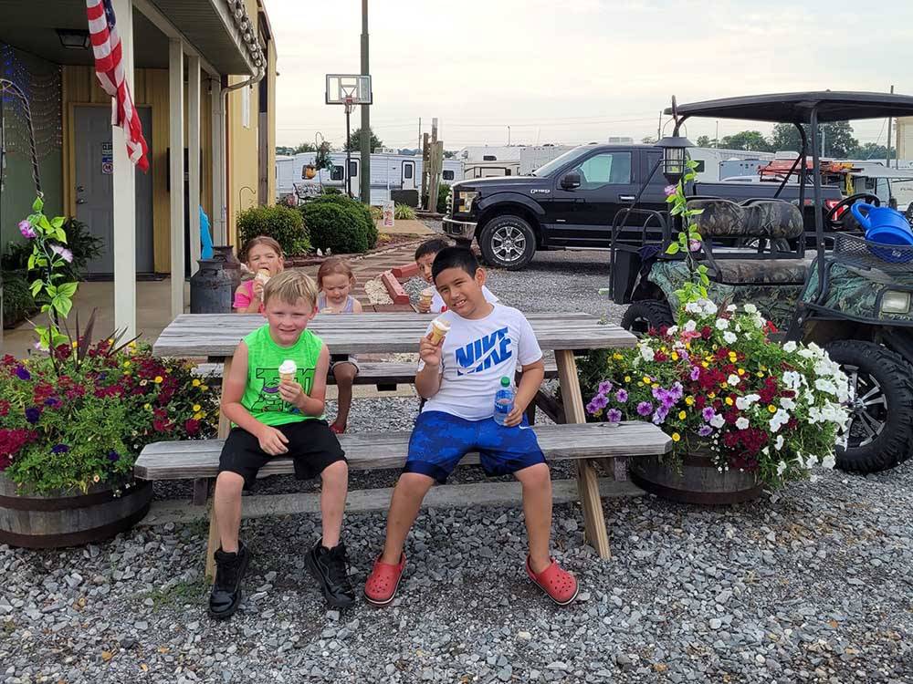 Friends hanging out at picnic table at COYOTE VIEW RV PARK & RV REPAIR