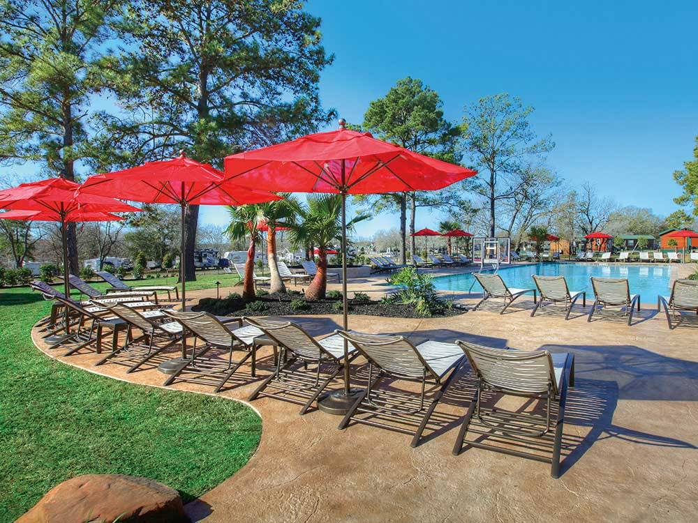 Swimming pool with outdoor seating at THOUSAND TRAILS LAKE CONROE
