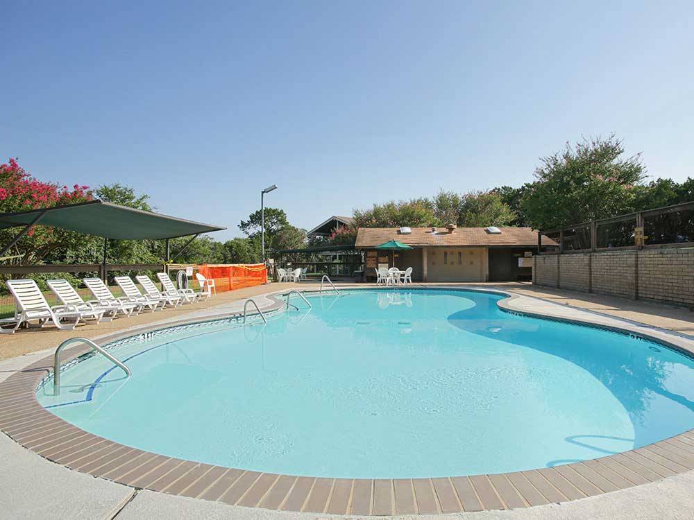 Swimming pool with outdoor seating at THOUSAND TRAILS LAKE WHITNEY