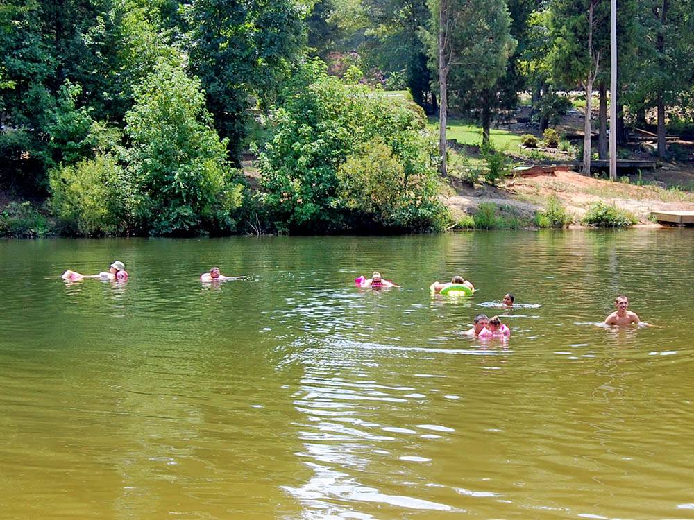 People swimming in the lake at THOUSAND TRAILS FOREST LAKE