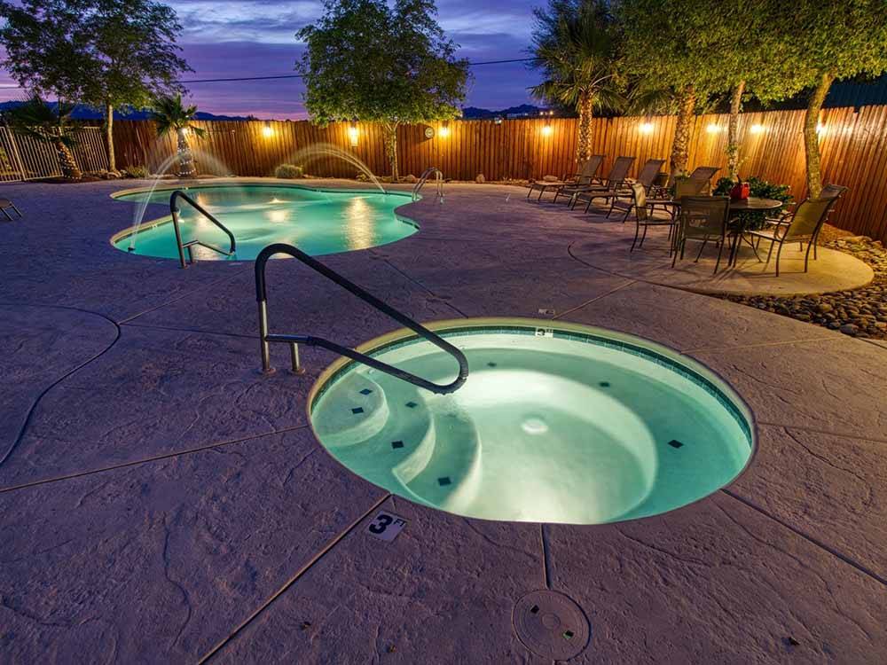 The swimming pool and hot tub at dusk at CAMPBELL COVE RV RESORT