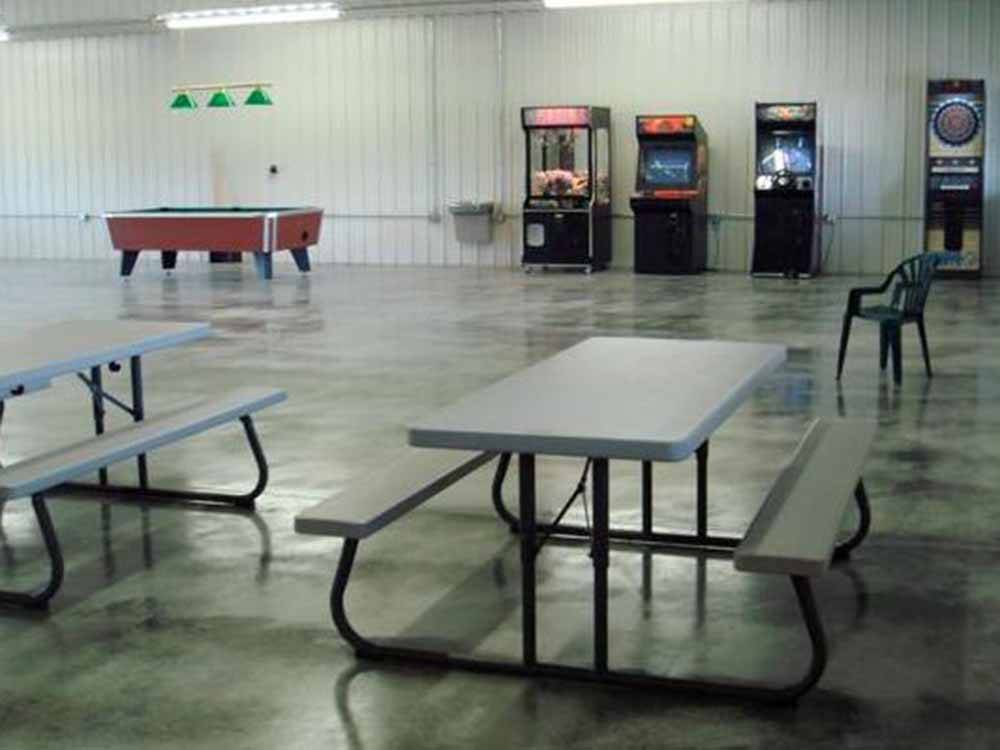 Picnic tables in the rec hall at FOLLOW THE RIVER RV RESORT