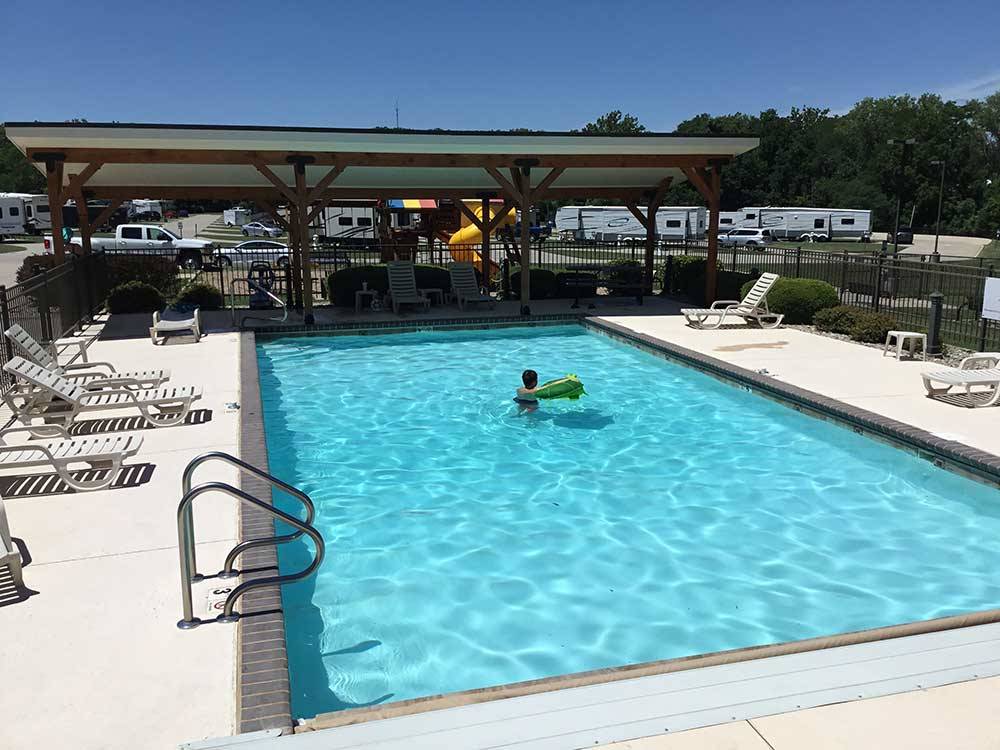 A person enjoying the swimming pool at DEER CREEK VALLEY RV PARK