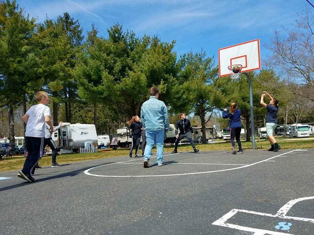 People playing on the basketball court at ATLANTIC BLUEBERRY RV PARK