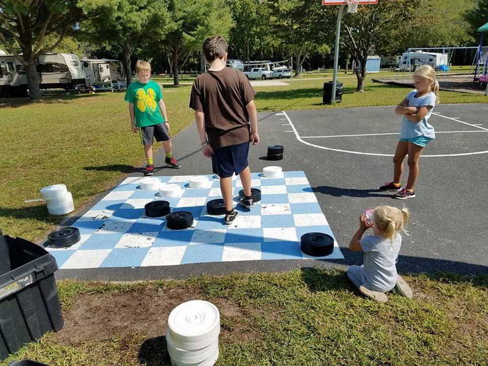 Kids playing with oversized checkers ATLANTIC BLUEBERRY RV PARK